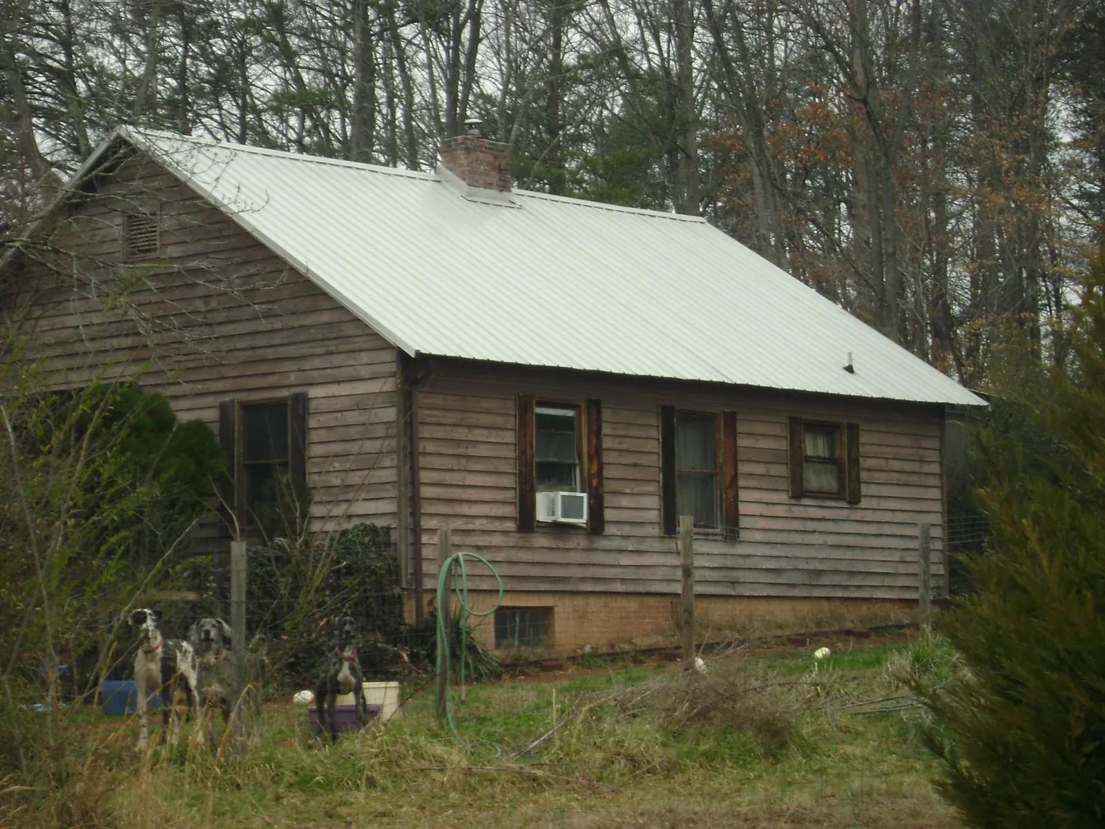 White metal roof on an old wood sided farmhouse, from a Metal Roof Installation job in Rogerson